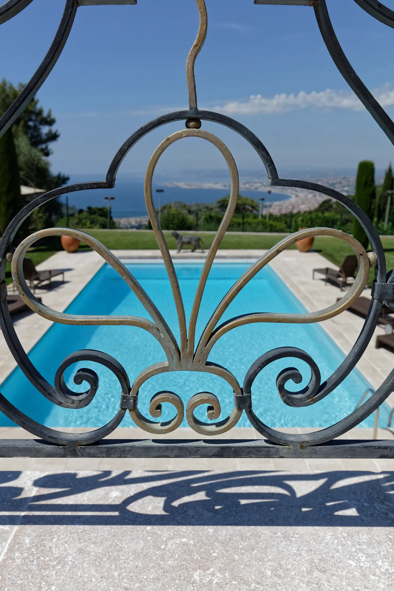 Côte d’Azur — Wrought-iron gate framing the pool